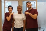 Happy patient and clinic team after Hollywood Smile treatment